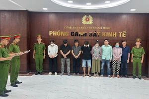 Công an đọc lệnh bắt tạm giam các bị can trong đường dây sản xuất hàng giả là thực phẩm. Ảnh: Công an TPHCM.