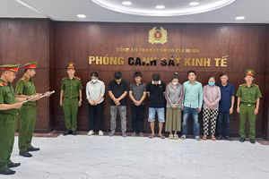 Công an đọc lệnh bắt tạm giam các bị can trong đường dây sản xuất hàng giả là thực phẩm. Ảnh: Công an TPHCM.