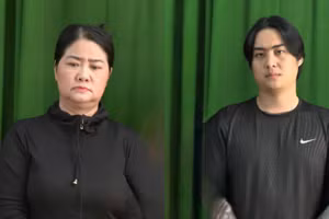 Lâm Thị Thu Em (trái) và con trai Nguyễn Văn Đang tại cơ quan điều tra. (Ảnh: Công an TPHCM)