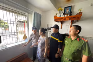 Ông Mai Quang, Phó Chủ tịch UBND phường Bình Quới (trái) cùng lực lượng chức năng vận động người dân Chung cư Thanh Đa tháo dỡ "chuồng cọp". Ảnh: Hà An.