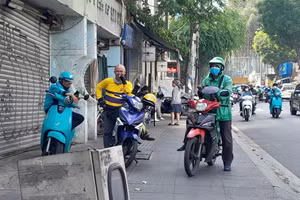 Lực lượng xe ôm công nghệ đang nghỉ ngơi chờ khách tại TPHCM. (Ảnh: Hà An)