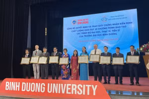 Cán bộ, giảng viên Trường Đại học Bình Dương đại diện cho 10 ngành đào tạo nhận chứng nhận kiểm định. Ảnh: Hà An.