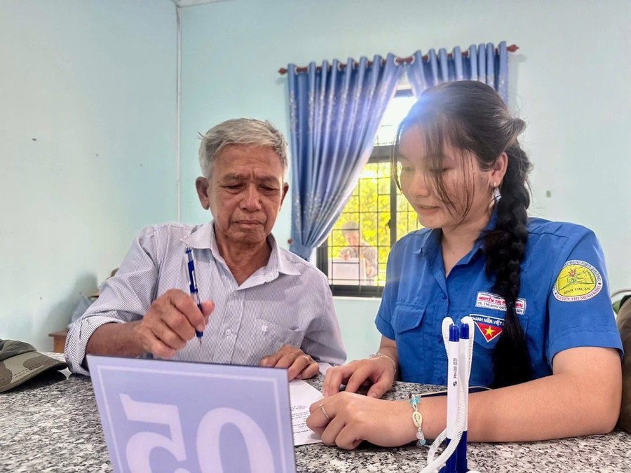 Đoàn viên thanh niên hướng dẫn người dân sử dụng dịch vụ công trực tuyến và thanh toán điện tử.