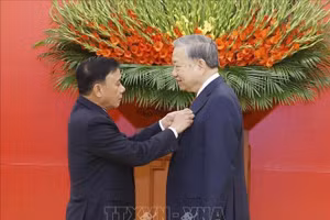 Đồng chí Trần Cẩm Tú, Uỷ viên Bộ Chính trị, Thường trực Ban Bí thư trao Huy hiệu Đảng tặng Tổng Bí thư Tô Lâm. Ảnh: Thống Nhất/TTXVN