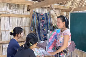 Nghệ nhân Châu Mạ hướng dẫn sinh viên tìm hiểu chi tiết thổ cẩm dân tộc Châu Mạ. Ảnh: NVCC. 