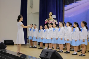 Dàn hợp xướng Thanh thiếu niên Hàn Quốc tại TPHCM trình bày liên khúc "Xin hãy ôm tôi thật chặt”, “Ngôi sao”, và "Thế giới tươi đẹp” tại lễ khai mạc. Ảnh: Lý Nguyên.