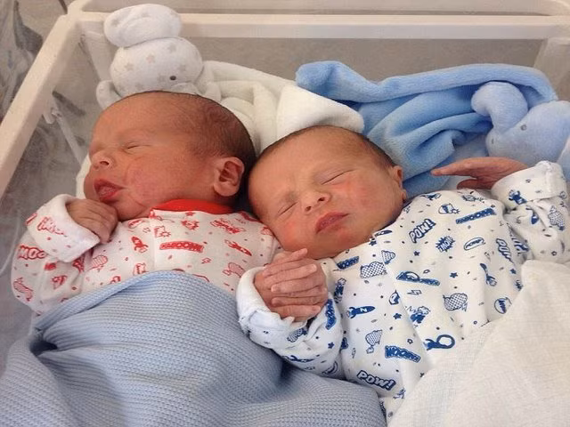 Anh em song sinh nắm chặt tay nhau khi vừa ra đời