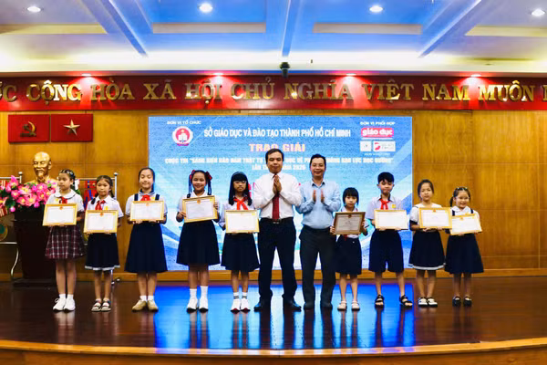 Hoàng Đức Minh, Vụ trưởng Vụ học sinh Sinh viên (Bộ GD&ĐT) và Trần Nguyên Hãn, Giám đốc Công ty TNHH Tư vấn & Đào tạo Đại Dương trao giải cho các em học sinh.