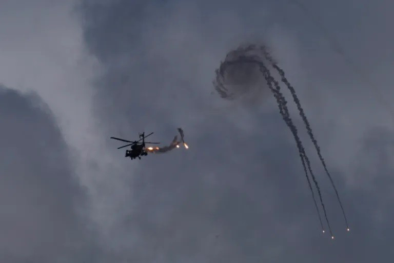 Một trực thăng tấn công Apache của Israel thả pháo sáng gần biên giới Lebanon hôm 2/10. Ảnh: Baz Ratner/AP