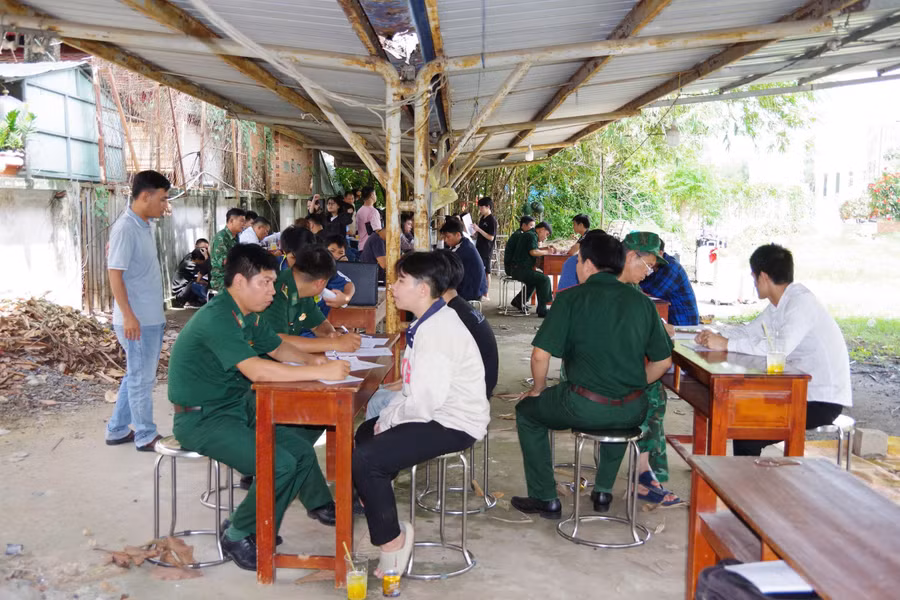 Bộ đội Biên phòng Cửa khẩu Quốc tế Mộc Bài tiếp nhận công dân Việt Nam từng làm việc ở Campuchia. (Ảnh: Phúc Uyên)