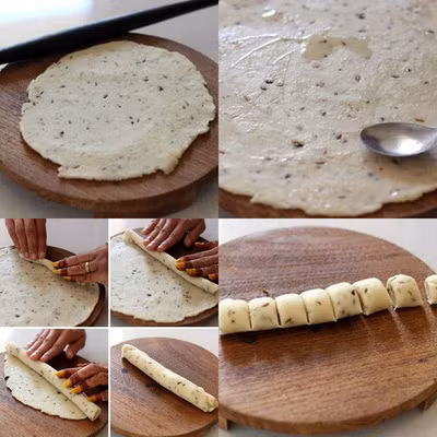 Đặt bột lên thớt, dùng dụng cụ cán bột để dàn phẳng bột ra cho thật mỏng. Lấy 1 thìa nhúng qua dầu ăn để phết đều lên mặt bột. Sau đó dùng tay cuộn bột lại như hình. Dùng dao sắc cắt bột thành từng đoạn, mỗi đoạn khoảng 1-1,5cm.