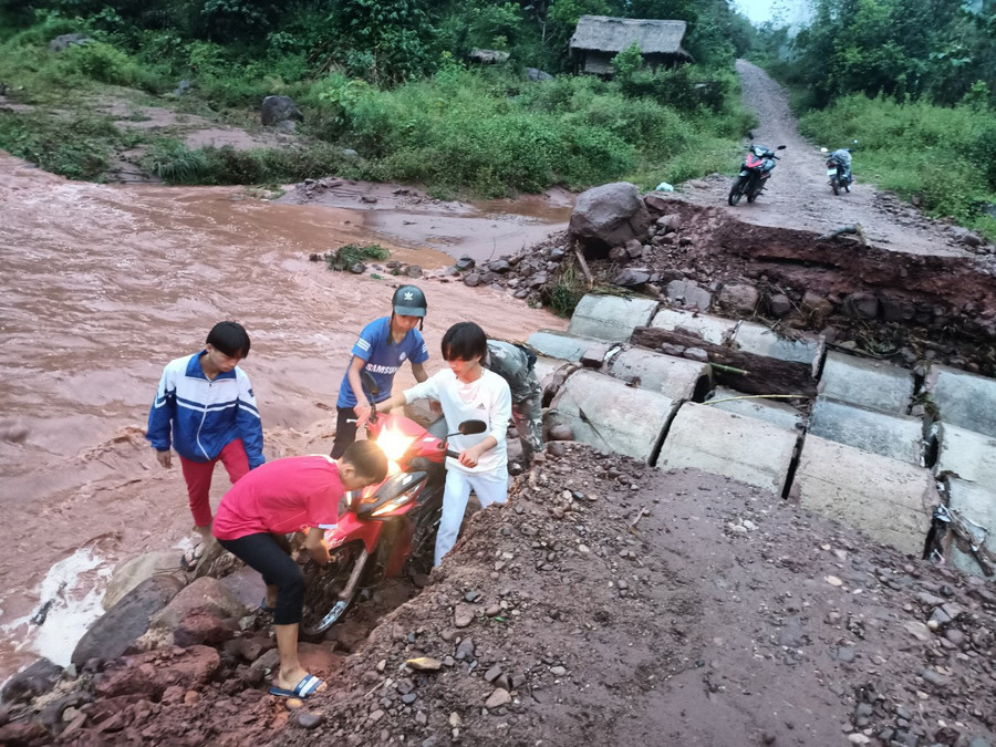 Bề mặt ngầm tràn bị cuốn trôi khiến việc di chuyển của người dân gặp nhiều khó khăn.