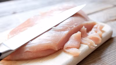 Thịt ức gà rửa sạch thái thành lát mỏng dài.