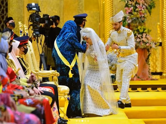 Cô dâu và chú rể chào Quốc vương và người vợ đầu tiên của ông.