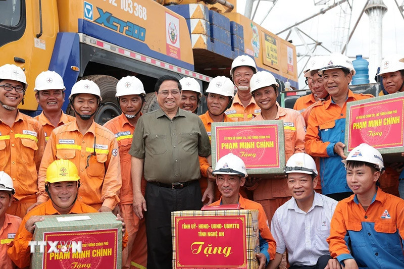 Thủ tướng Phạm Minh Chính tặng quà kỹ sư, công nhân các đơn vị đang thi công dự án đường dây tải điện 500kV mạch 3 Quảng Trạch-Phố Nối đoạn qua tỉnh Nghệ An. (Ảnh: Dương Giang/TTXVN). Thủ tướng Phạm Minh Chính tặng quà kỹ sư, công nhân các đơn vị đang thi công dự án đường dây tải điện 500kV mạch 3 Quảng Trạch-Phố Nối đoạn qua tỉnh Nghệ An. (Ảnh: Dương Giang/TTXVN).