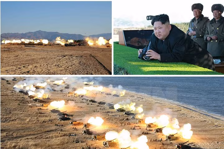 Nhà lãnh đạo Triều Tiên Kim Jong-ul (ảnh trên, góc phải) đã thị sát và chỉ đạo một cuộc tập trận pháo binh. (Nguồn: Yonhap/TTXVN) 