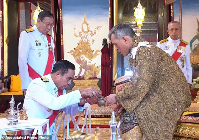 Vua Vajirusongkorn, phải, tham dự buổi lễ xức dầu tại Cung điện.