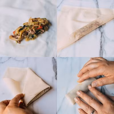 Trải bánh tráng ra mặt phẳng, cho nhân vào giữa, căn cho lượng nhân vừa phải, nếu ít thì không ngon mà nhiều quá thì cuốn sẽ không đẹp. Sau đó gấp mép hai bên và cuộn chả ram lại.