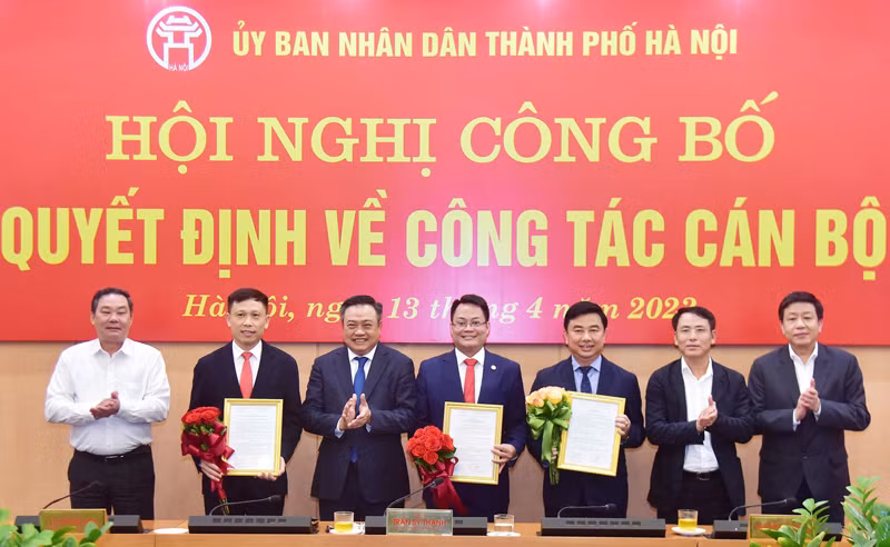 Chủ tịch UBND TP Hà Nội - Trần Sỹ Thanh (thứ 3 từ trái sang phải) trao quyết định, tặng hoa chúc mừng các cán bộ nhận nhiệm vụ mới.