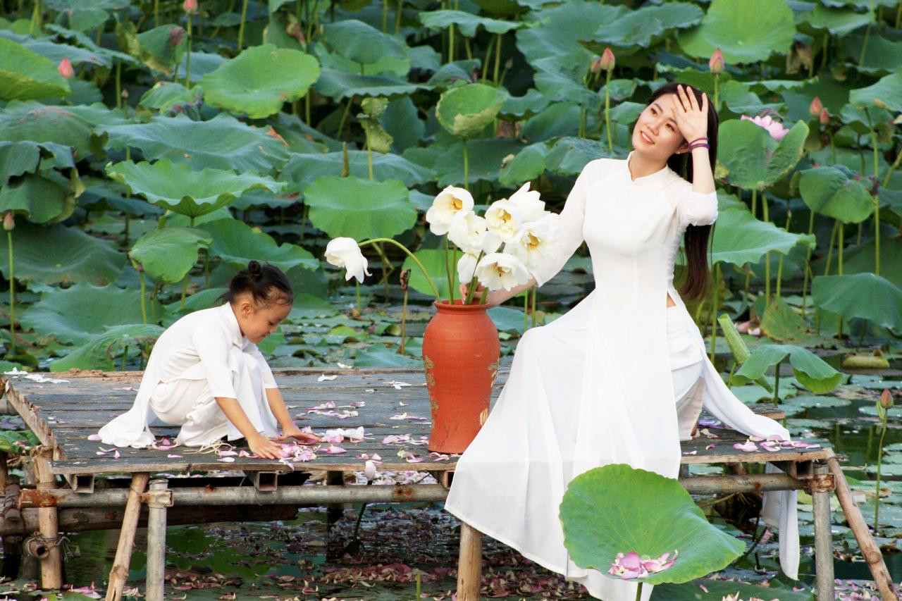 Một số bà mẹ trẻ đưa con đi ngắm cảnh cũng rất háo hức, say mê cùng con tạo dáng chụp ảnh bên hoa sen. Một số bà mẹ trẻ đưa con đi ngắm cảnh cũng rất háo hức, say mê cùng con tạo dáng chụp ảnh bên hoa sen.