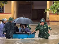 Cán bộ, chiến sĩ Bộ đội Biên phòng Hà Tĩnh dùng thuyền thúng đưa giáo viên và học sinh đến nơi an toàn.