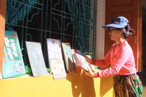 Giáo viên Trường Tiểu học Tân Lâm Hương (Thạch Hà, Hà Tĩnh) phơi sách sau trận lụt 2020. Ảnh: Hồ Phương