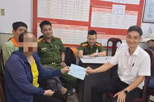 Lực lượng Công an và nhân viên ngân hàng làm thủ tục trao tiền lại cho bà P. Ảnh: CACC