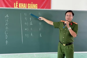 Lực lượng Công an hướng dẫn các học viên nhận biết mặt chữ cái tại lớp xóa mù chữ.