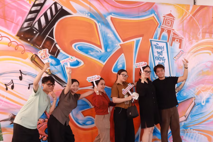 Các sinh viên hào hứng check-in cùng background graffiti SA7GON. 