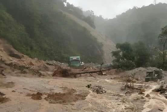 Một ô tô lưu thông qua QL 8A bị sa lầy do bùn đất.