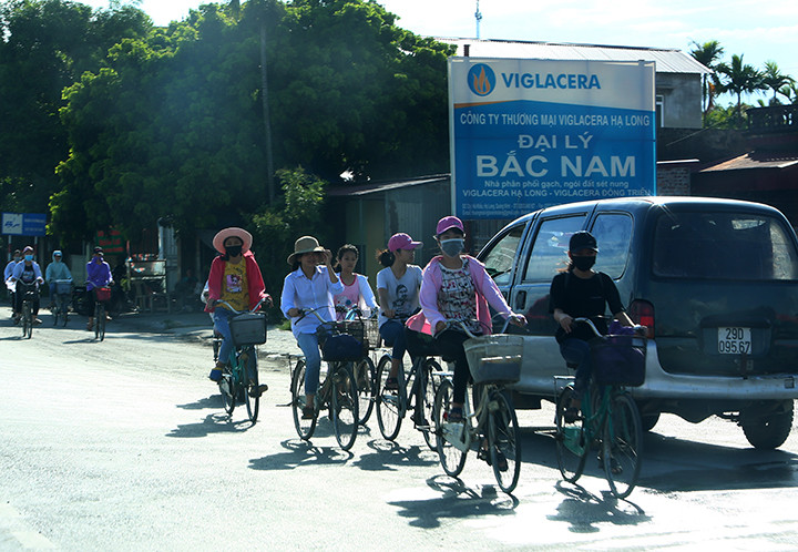 Vào giờ tan tầm, xe máy, xe đạp đi thành hàng dài ngược 2 bên đường.