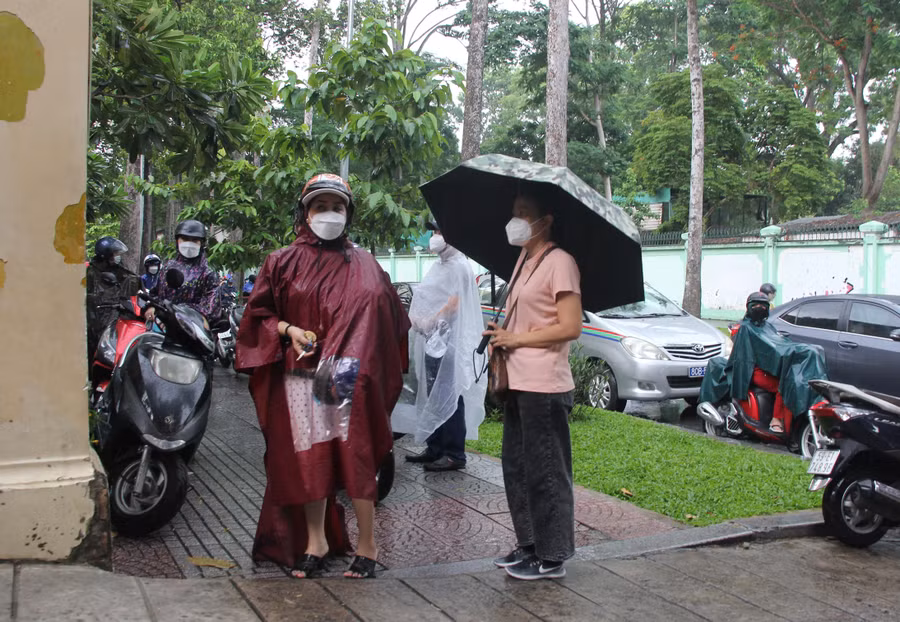 Dù trời đổ cơn mưa, nhưng các bậc phụ huynh vẫn kiên nhẫn chờ con ngoài cổng trường thi.