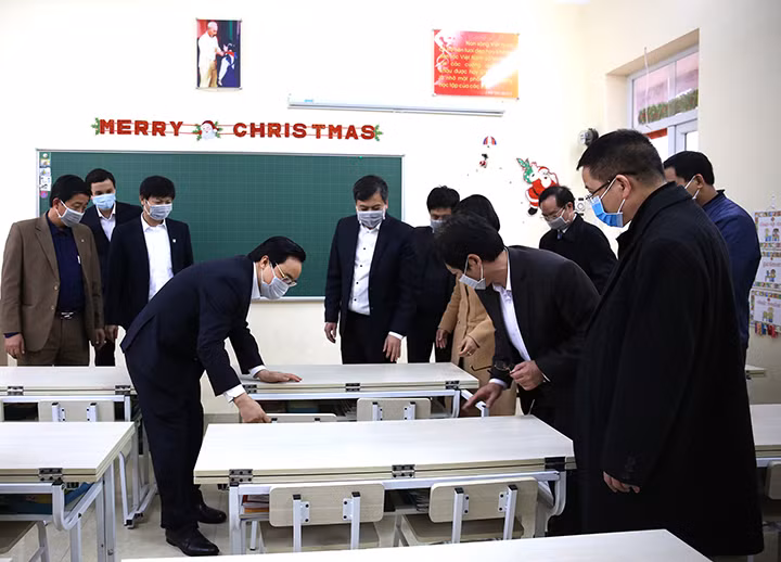 Bộ trưởng Phùng Xuân Nhạ kiểm tra bàn học của các lớp trường Tiểu học Trần Nhân Tông (Nam Định).
