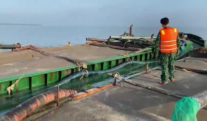 Cán bộ Đồn Biên phòng Long Hòa đang tiến hành kiểm tra 2 phương tiện vận chuyển cát trái phép.