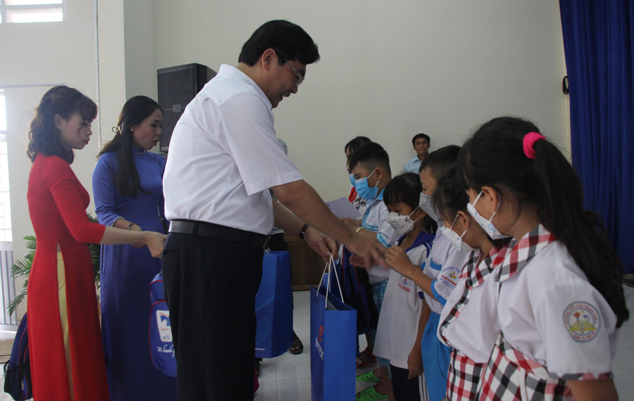 Ông Trần Thanh Bình trao học bổng và quà cho các em học sinh,