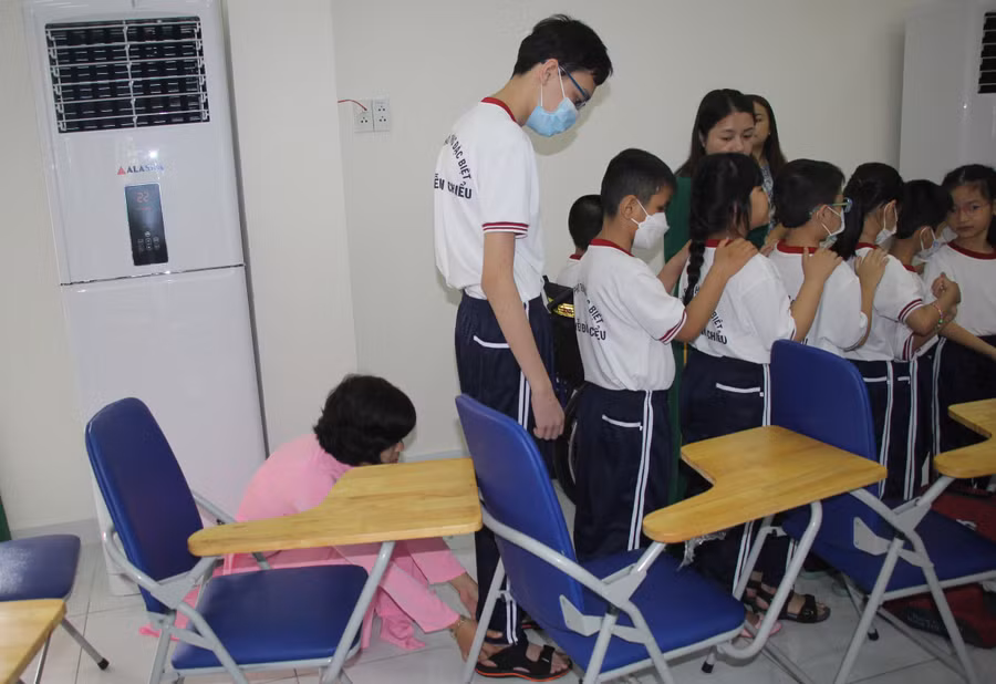 Cô giáo chỉnh sửa lại đồng phục cho học sinh trước khi lên sân khấu.