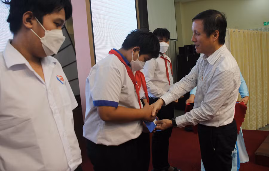 Ông Nguyễn Xuân Dũng trao học bổng cho các em học sinh.