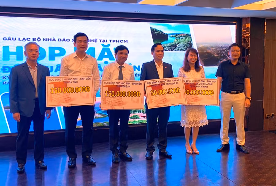 Lãnh đạo các đơn vị tiếp nhận biểu trưng 400 suất học bổng cho học sinh, sinh viên có hoàn cảnh khó khăn.