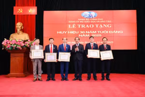 Bí thư Đảng ủy, Bộ trưởng Nguyễn Kim Sơn trao Huy hiệu 30 năm tuổi Đảng cho các đảng viên thuộc Đảng bộ Bộ GD&ĐT. 