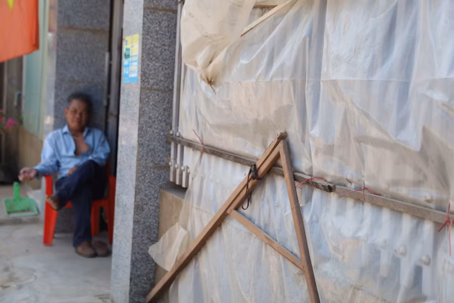 Người dân che chắn để giảm bớt bụi bay vào nhà.