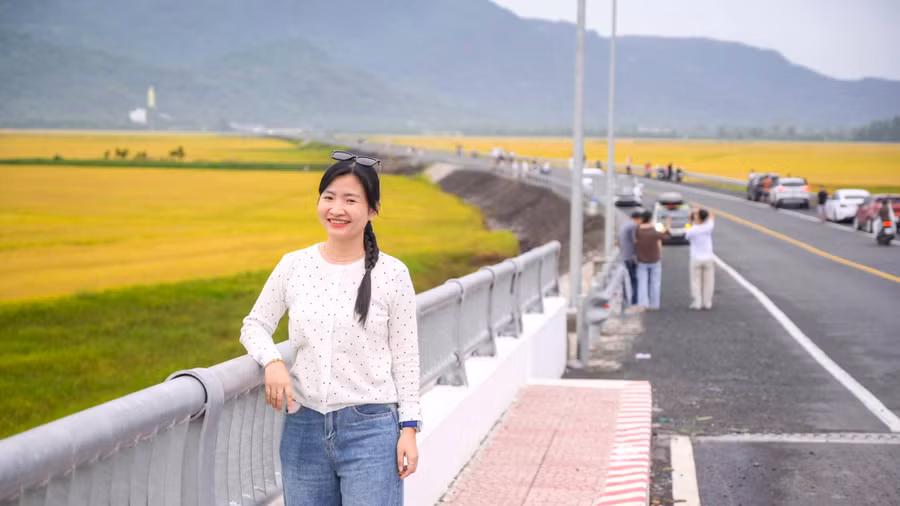 Chị Như Ngọc tạo dáng bên cung đường uốn lượn giữa đồng ruộng và núi non.