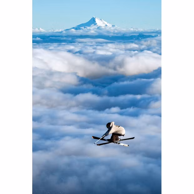 A skier jumps off Mount Hood in Oregon, USA. Jumping thousands of feet into the air with the clouds beneath their feet, these fearless sky skiers take off-piste to a whole new level. The daredevil skiers performed a series of impressive stunts above the clouds.