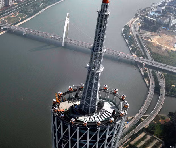 The worlds highest Ferris wheel is set to open for business on top of a 1,480ft tower in China - with passengers riding in see-through pods. Built on the 450-meter-high Canton Tower, the amazing wheel consists of 16 pods holding a total of 96 fearless passengers. Each capsule is just over three meters wide, and built using a special macromolecule material which allows a 360-degree crystal clear view. Unlike other Ferris wheels, it has a 15-degree incline and can resist 8-magnitude earthquakes and Beaufort scale 12 typhoons