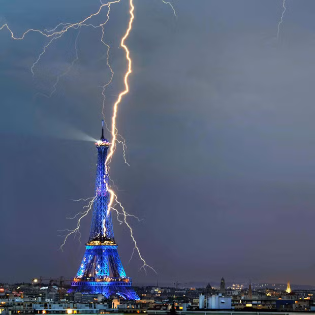 A lightning bolt appears to strike the Eiffel Tower in Paris