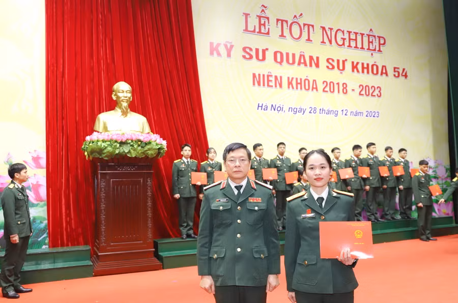 Thiếu tướng Trần Văn Thưởng - Bí thư Đảng uỷ, Chính uỷ Học viện Kỹ thuật Quân sự trao bằng tốt nghiệp cho Bùi Thị Thoa.