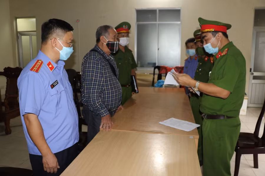 Cơ quan chức năng tống đạt quyết định khởi tố bị can và thi hành lệnh bắt tạm giam đối với ông Nguyễn Đình Khang. Ảnh: Công an Nghệ An.