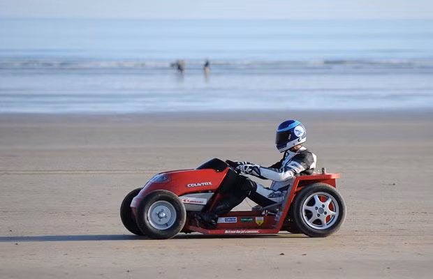Lawnmower driver Don Wales on his successful record-breaking run on Pendine Sands in west Wales. The jet-red lawn mower hit 86.069mph, adding almost 6mph to a previous top speed set in America four years ago