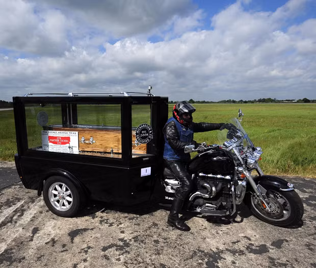 The Reverend Ray Biddiss parks his motorbike after setting a Guinness World Record for the world’s fastest motorcycle hearse after he set a new record of 114mph at Elvington airfield in Yorkshire