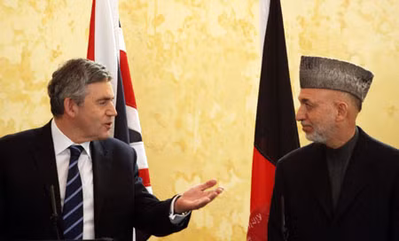 Britain’s Prime Minister, Gordon Brown, left, speaks to Afghanistan President Hamid Karzai during a press conference at Kandahar Airbase on Sunday Dec. 13, 2009 in Kandahar, Afghanistan. Gordon Brown travelled to Afghanistan for an unannounced pre-Christmas visit to British troops which was followed by talks with Afghanistan President Hamid Karzai.