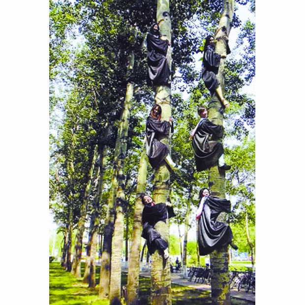 Six female students from a university in China have become a hit on the internet after taking a very unusual graduation photo. The six students from a university in Beijing climbed up two trees - with three people on each - before clinging tightly to the trunks and giving the waiting photographer a nice smile. The image was uploaded to the internet with the title 